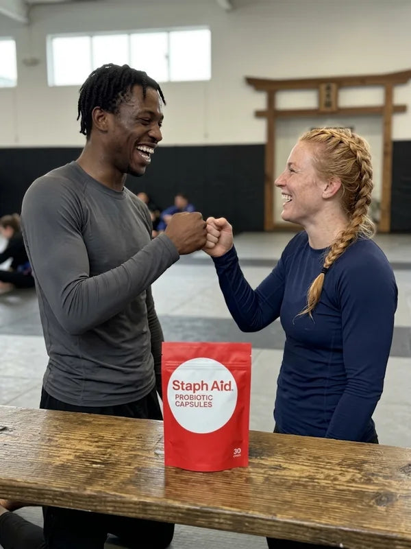Two jiu-jitsu athletes training on the mats